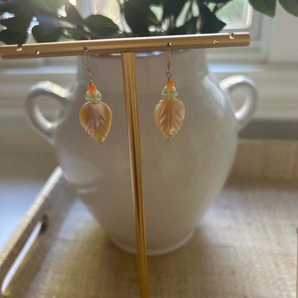 Miguel Ases  drop earrings with feather, motif and beautiful, coral beading